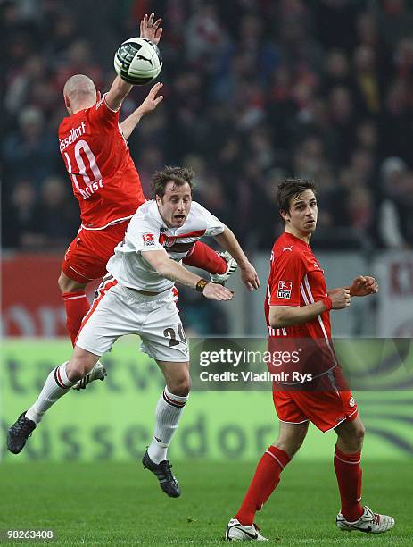 Matthias Lehmann of St. Pauli and Marco Christ jump for a header as Martin Harnik of Fortuna looks on during the Second Bundesliga match between...