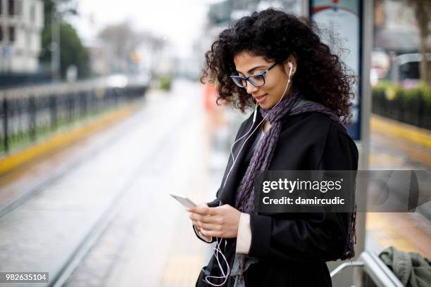 woman waiting for train at the station - rush hour stock pictures, royalty-free photos & images