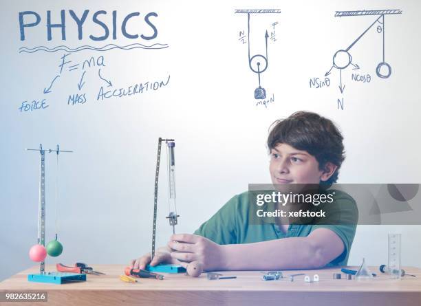 kid is doing experiments about physics. - pendulum like stock pictures, royalty-free photos & images