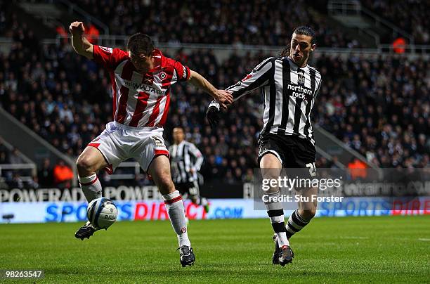 Newcastle United striker Andy Carroll battles for possesion with Sheffield United defender Chris Morgan the Coca-Cola Championship game between...