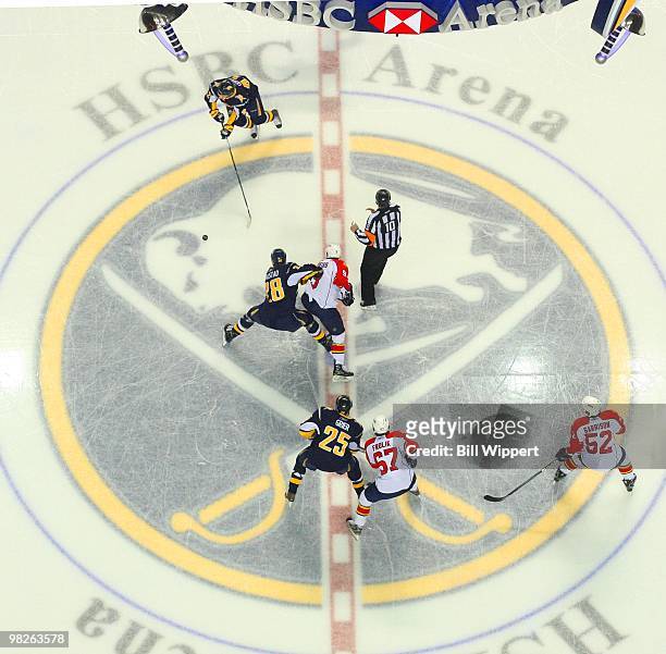 Paul Gaustad, Nathan Gerbe and Michael Grier of the Buffalo Sabres faceoff against the Florida Panthers on March 31, 2010 at HSBC Arena in Buffalo,...