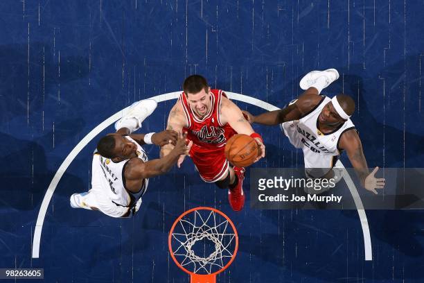 Brad Miller of the Chicago Bulls shoots a layup against Hasheem Thabeet and Zach Randolph of the Memphis Grizzlies during the game at the FedExForum...