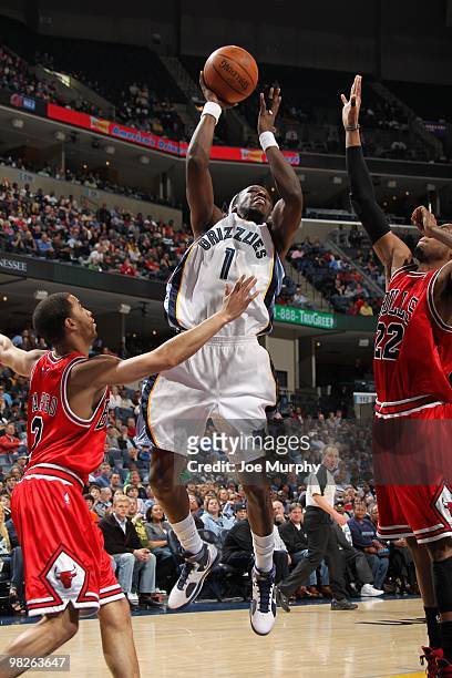 DeMarre Carroll of the Memphis Grizzlies goes up for a shot against Taj Gibson and Jannero Pargo of the Chicago Bulls during the game at the...