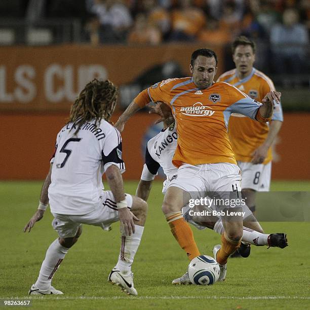 Ryan Cochrane of the Houston Dynamo brings the ball up the field as he is defended by Kyle Beckerman of Real Salt Lake on April 1, 2010 in Houston,...