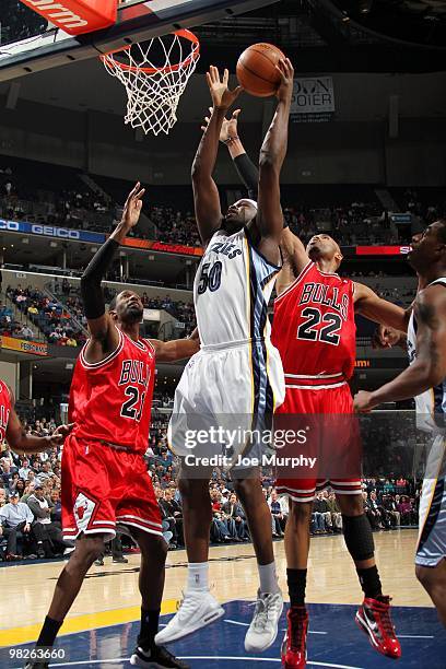 Zach Randolph of the Memphis Grizzlies goes up for a shot against Taj Gibson and Hakim Warrick of the Chicago Bulls during the game at the FedExForum...