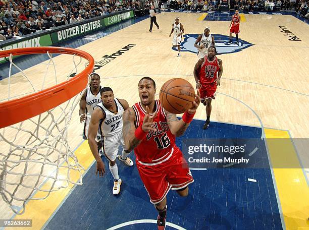 James Johnson of the Chicago Bulls shoots a layup against Rudy Gay of the Memphis Grizzlies during the game at the FedExForum on March 16, 2010 in...