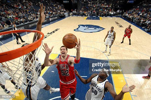 Brad Miller of the Chicago Bulls shoots a layup against Hasheem Thabeet and Zach Randolph of the Memphis Grizzlies during the game at the FedExForum...