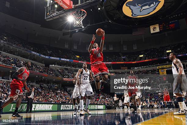 James Johnson of the Chicago Bulls shoots a layup against Rudy Gay of the Memphis Grizzlies during the game at the FedExForum on March 16, 2010 in...