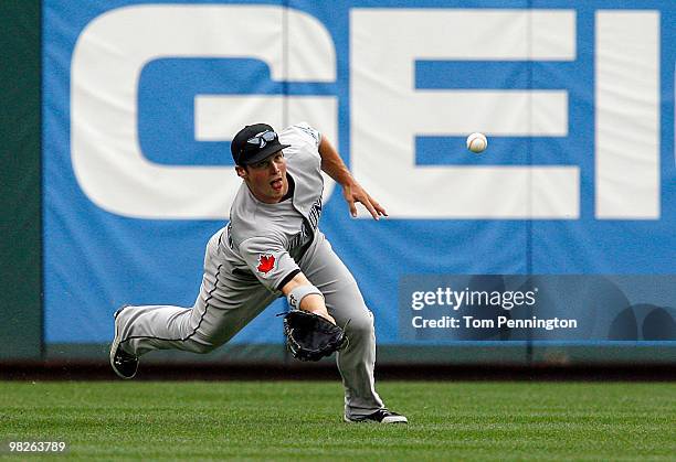 Left fielder Travis Snider of the Toronto Blue Jays makes the catch for the out in the bottom of the second inning against the Texas Rangers on...