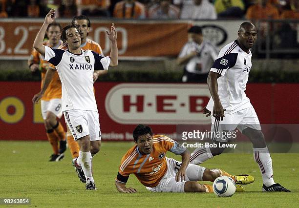 Brian Ching of the Houston Dynamo is knocked down by Ned Grabavoy of Real Salt Lake reacts to the referees call on April 1, 2010 in Houston, Texas.