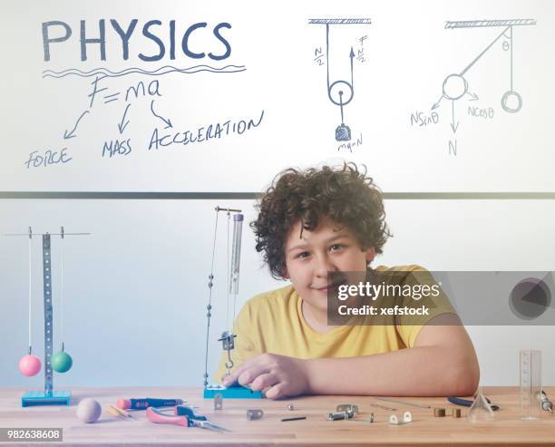 kid is doing experiments about physics. - pendulum like stock pictures, royalty-free photos & images