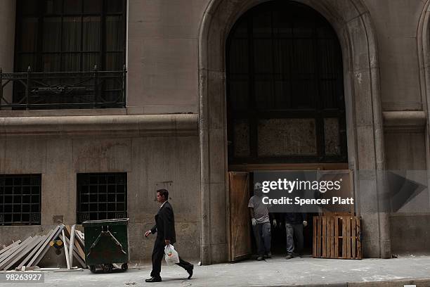 Man walks by an office building undergoing renovations in the financial district on April 5, 2010 in New York City. Office vacancy rates have hit...