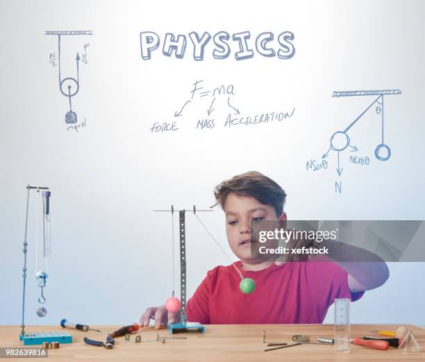 kid is doing experiments about physics. - pendulum like stock pictures, royalty-free photos & images