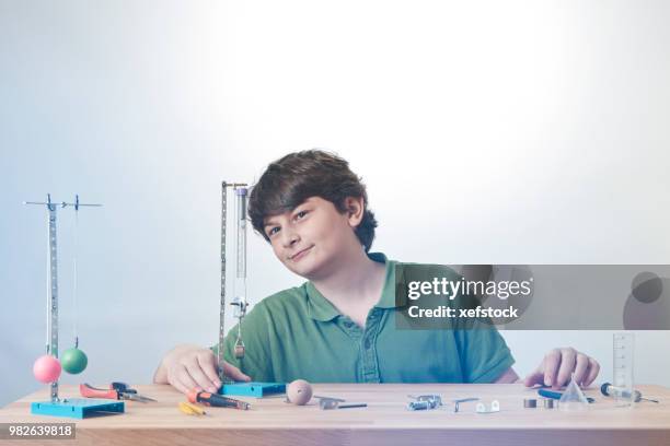 kid is doing experiments about physics. - pendulum like stock pictures, royalty-free photos & images