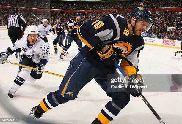 Henrik Tallinder of the Buffalo Sabres skates away from Martin St. Louis of the Tampa Bay Lightning on March 27, 2010 at HSBC Arena in Buffalo, New...