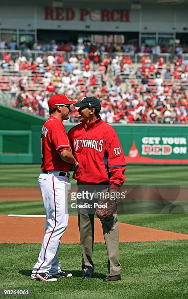 President Barack Obama is congratulated by Nationals third baseman Ryan Zimmerman after Obama threw out the opening pitch before the game between the...