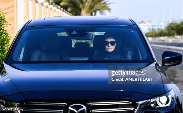 Hala Hussein Alireza, a newly-licensed Saudi motorist, drives a car on a main road in the Red Sea coastal city of Jeddah early on June 24, 2018. -...