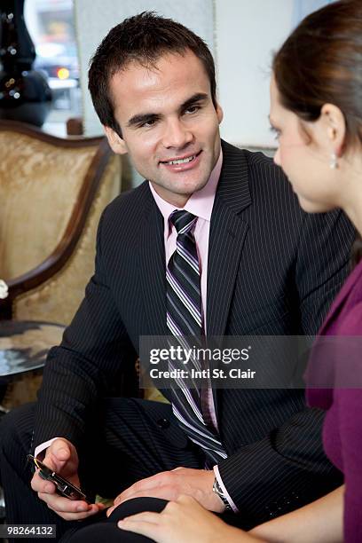 business professionals talking with mobile phone - inti st clair stock pictures, royalty-free photos & images