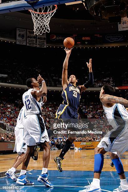 Danny Granger of the Indiana Pacers puts a shot up over Dwight Howard of the Orlando Magic during the game on January 20, 2010 at Amway Arena in...