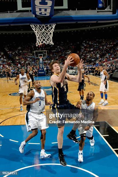 Troy Murphy of the Indiana Pacers goes up for a shot over Rashard Lewis and Jameer Nelson of the Orlando Magic during the game on January 20, 2010 at...