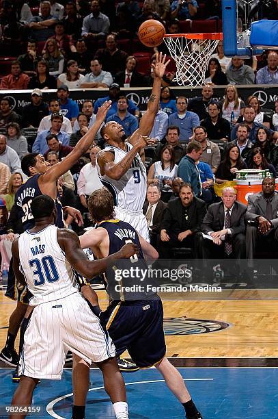 Rashard Lewis of the Orlando Magic lays the ball up over Danny Granger of the Indiana Pacers during the game on January 20, 2010 at Amway Arena in...