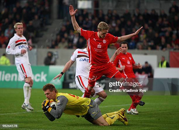 Michael Ratajczak saves the ball as his team mate Johannes van den Bergh of Fortuna defends during the Second Bundesliga match between Fortuna...