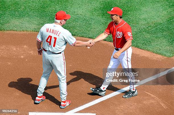 Manager Jim Riggleman of the Washington Nationals shakes hands with Charlie Manuel of the Philadelphia Phillies on Opening Day at Nationals Park on...