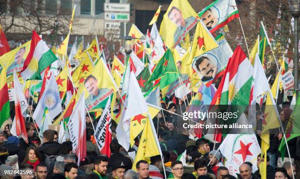 Dpatop - Kurdish Protestors wave flags and hold pictures of imprisoned Kurdish PKK leader Abdullah Ocalan during a protest against the Turkish...