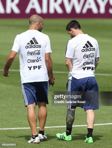 Javier Mascherano of Argentina and Lionel Messi of Argentina talk during a training session at Stadium of Syroyezhkin sports school on June 24, 2018...