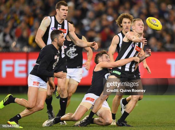 Jaidyn Stephenson of the Magpies is tackled by Dale Thomas of the Blues during the round 14 AFL match between the Collingwood Magpies and the Carlton...