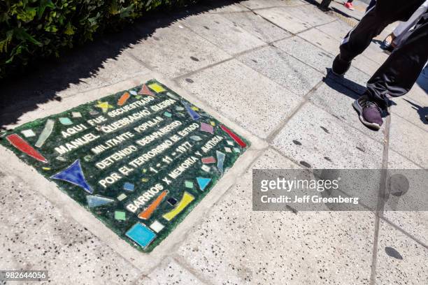 Argentina, Buenos Aires, Avenida Las Heras, sidewalk memorial plaque for political dissidents.