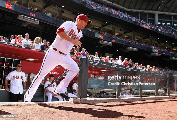 Adam LaRoche of the Arizona Diamondbacks runs out onto the field as he is introduced to the Opening Day major league baseball game against the San...