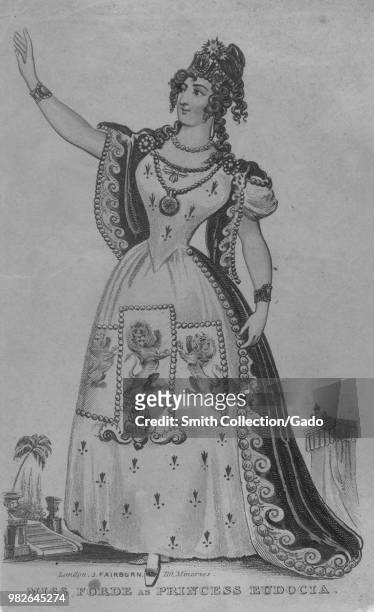Black and white print depicting a full-length portrait of British actor Miss Forde, reaching one arm forward and looking away from the viewer,...