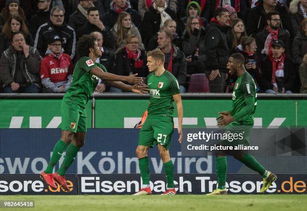 Augsburg's Caiuby Alfred Finnbogason and Jan-Ingwer Callsen-Bracker celebrate Caiuby's goal for 1:1 during the German Bundesliga football match...