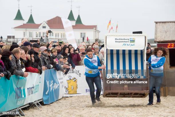 Participants sprint down the beach on the island Usedom carrying wicker beach chairs at the Beach Chair Sprinting World Cup in Ahlbeck, Germany, 27...