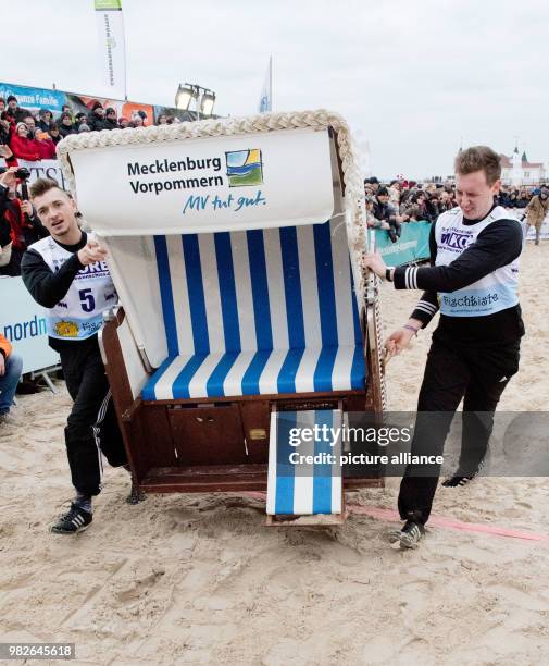Participants sprint down the beach on the island Usedom carrying wicker beach chairs at the Beach Chair Sprinting World Cup in Ahlbeck, Germany, 27...