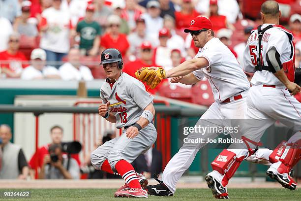 Brendan Ryan of the St. Louis Cardinals gets tagged out by Scott Rolen of the Cincinnati Reds at Great American Ballpark on March 5, 2010 in...