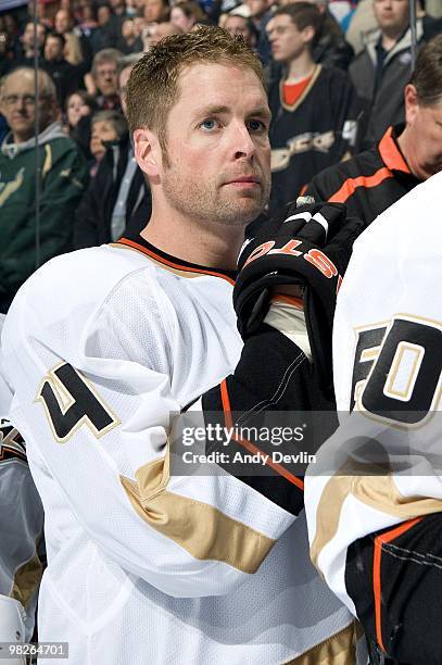 Aaron Ward of the Anaheim Ducks stands for the national anthems before a game against the Anaheim Ducks at Rexall Place on March 26, 2010 in...