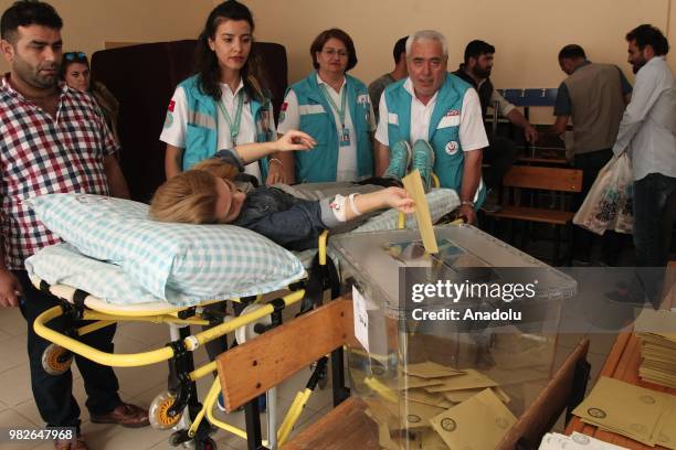 Patient on a stretcher casts her ballot at a polling station during the parliamentary and presidential elections, in Kirklareli, Turkey on June 24,...