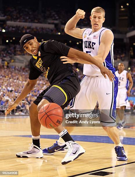 Kevin Jones of the West Virginia Mountaineers and Mason Plumlee of the Duke Blue Devils battle for a loose ball during the National Semifinal game of...