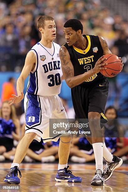 Kevin Jones of the West Virginia Mountaineers is guarded by Jon Scheyer of the Duke Blue Devils during the National Semifinal game of the 2010 NCAA...