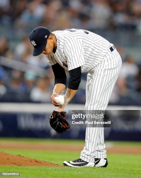 Pitcher Jonathan Loaisiga of the New York Yankees uses the rosin bag as he prepares to pitch in his major league debut in an MLB baseball game...