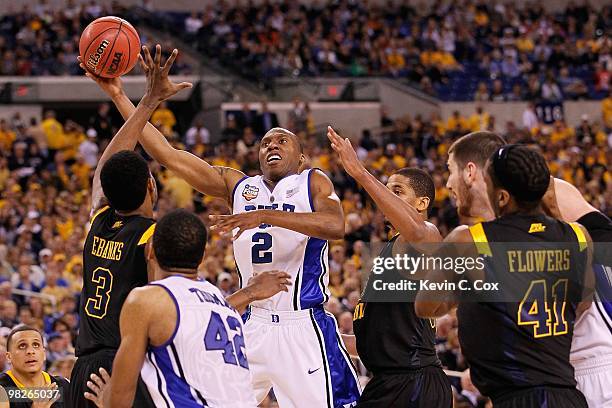 Nolan Smith of the Duke Blue Devils shoots over Devin Ebanks of the West Virginia Mountaineers during the National Semifinal game of the 2010 NCAA...