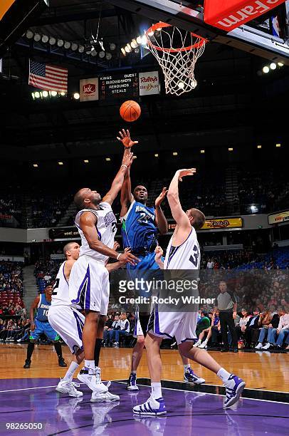 Al Jefferson of the Minnesota Timberwolves lays up a shot against Carl Landry and Spencer Hawes of the Sacramento Kings during the game on March 14,...
