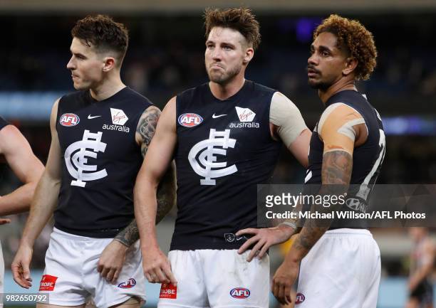 Aaron Mullett, Dale Thomas and Jarrod Garlett of the Blues look dejected after a loss during the 2018 AFL round 14 match between the Collingwood...