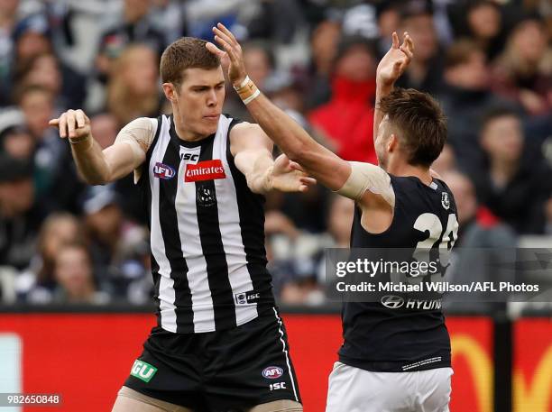 Mason Cox of the Magpies and Dale Thomas of the Blues clash during the 2018 AFL round 14 match between the Collingwood Magpies and the Carlton Blues...