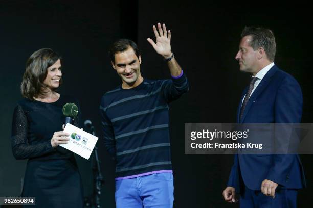 Presenter Franziska Schenk, tennis player Roger Federer and Ralf Weber, CEO Gerry Weber, attend the Gerry Weber Open Fashion Night 2018 at Gerry...