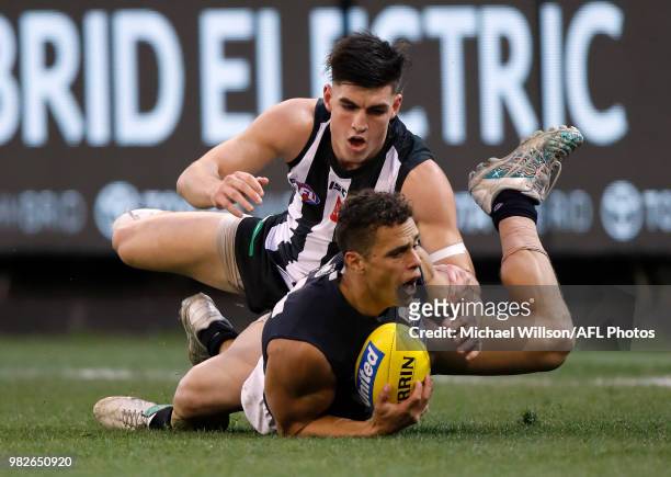 Ed Curnow of the Blues and Brayden Maynard of the Magpies compete for the ball during the 2018 AFL round 14 match between the Collingwood Magpies and...