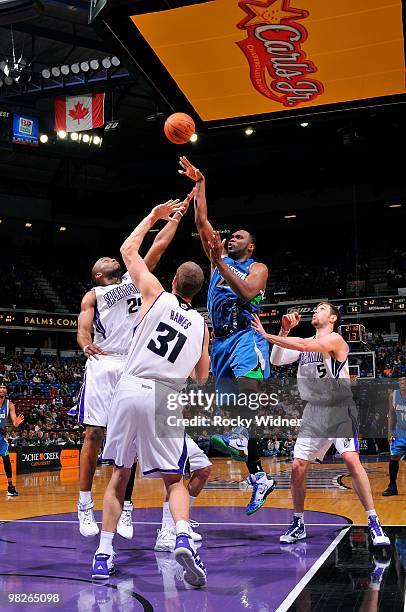 Al Jefferson of the Minnesota Timberwolves shoots against Carl Landry, Spencer Hawes and Andres Nocioni of the Sacramento Kings during the game on...