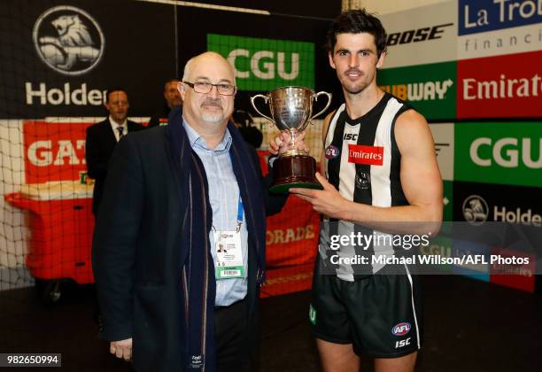 Scott Pendlebury of the Magpies is presented with the Peter Mac Cup during the 2018 AFL round 14 match between the Collingwood Magpies and the...